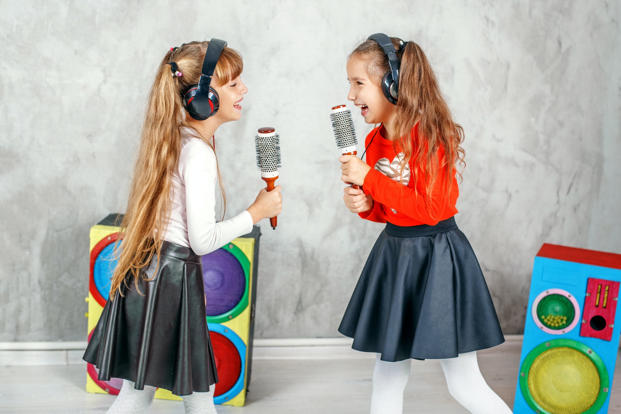Funny kids singing and listening to music on headphones. The con